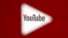 A 3D-printed YouTube icon is seen in front of a displayed YouTube logo - generic