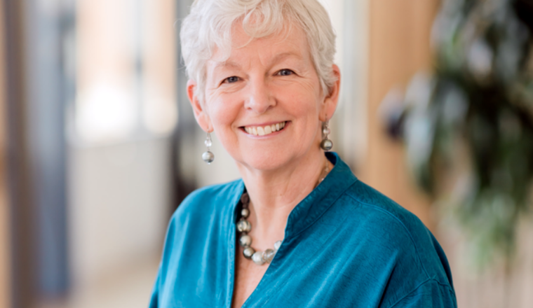 A woman smiling at camera.