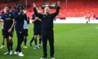 Dundee boss Tony Docherty celebrates with fans at Pittodrie. Image: Shutterstock