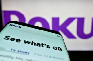 Stuttgart, Germany - 03-01-2022: Mobile phone with webpage of US video streaming company Roku Inc. on screen in front of business logo. Focus on top-left of phone display. Unmodified photo.