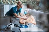 Female caregiver visits an elderly patient