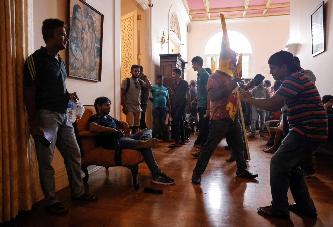 A demonstrator poses for a photograph after entering into the President's House