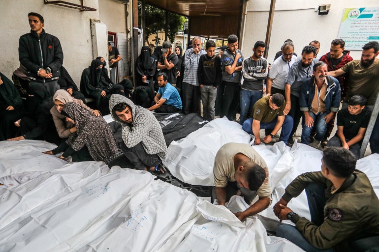 Relatives of Palestinian victims killed in Israeli attack take their bodies from morgue of al-Najjar Hospital in Rafah