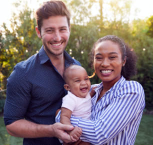 Happy couple holding smiling baby