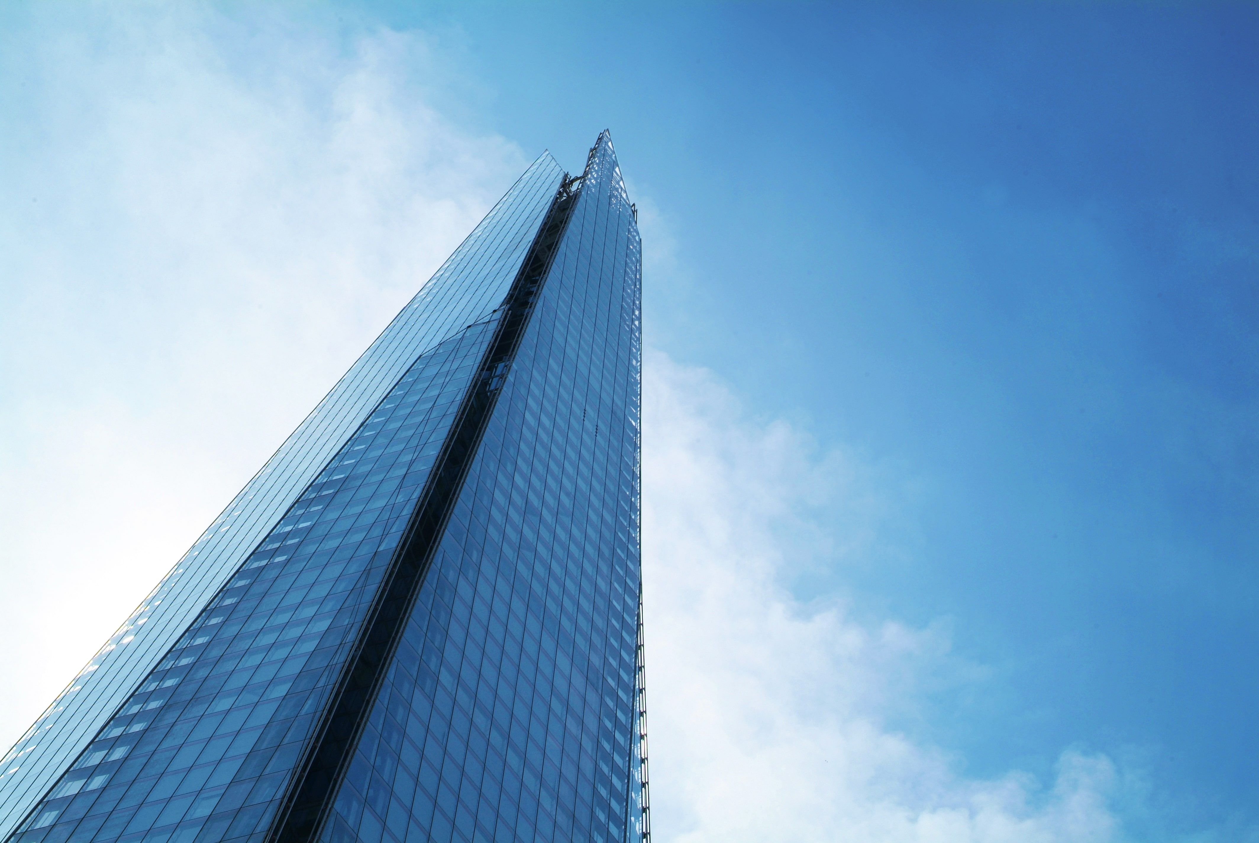 A view of the Shard from below against a blue sky