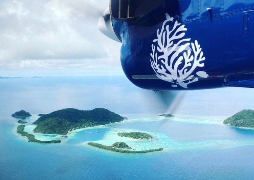 Seaplane arrival into private island Bawah Reserve, Indonesia.