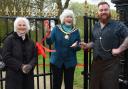 The mayor of Beccles, Christine Wheeler, cutting the ribbon to officially open the refurbished gates with new pillars. With her are Jennifer Langeskov, of the Beccles Townlands Charity, and Paul Stoddart.