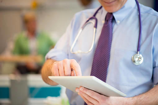 Senior doctor holding iPad