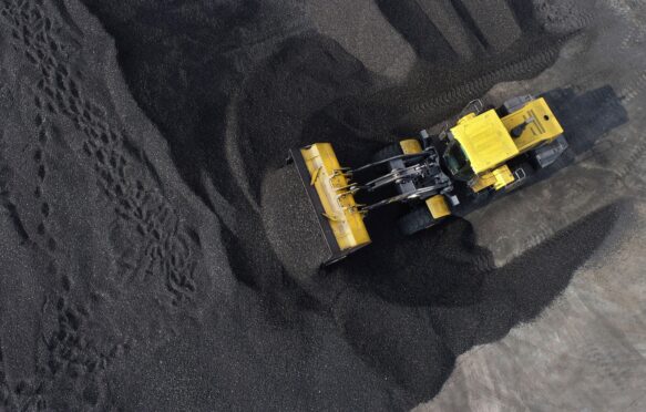 Large machines stack coal in Jiangsu Province, China.