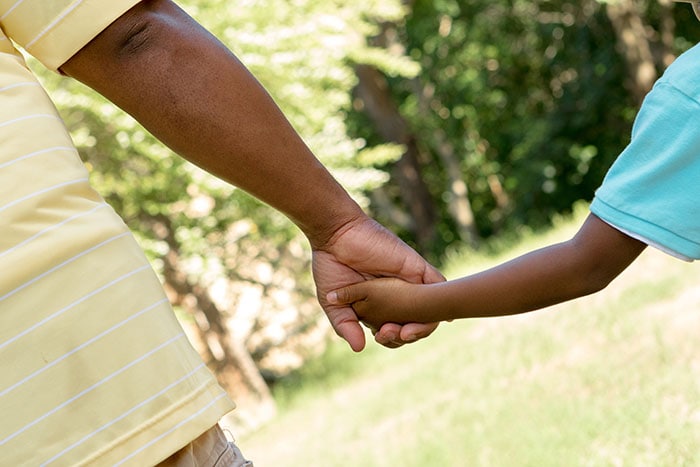 Father and son holding hands