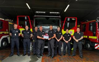 Mike Kerslade being handed his medal and certificate by Group Commander Ainsley Bird.