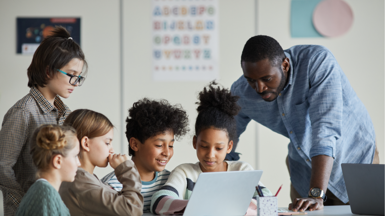 Kids at school working around a computer