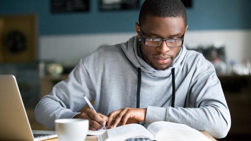 African American person studying at a desk