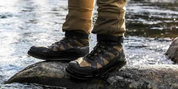 Hiking boots on a rock in a stream