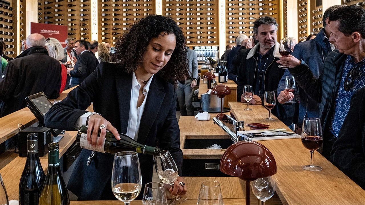 A waitress pours white wine in a glass in Dijon, Eastern France