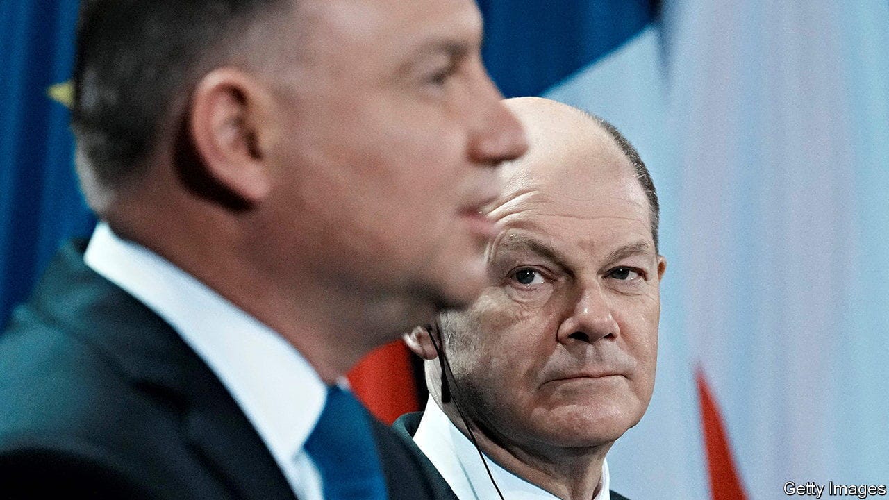 German Chancellor Olaf Scholz (R) listens to Polish President Andrzej Duda during a joint press conference with French President, on February 8, 2022 in Berlin. - Polish President Andrzej Duda said Tuesday he was confident war could still be averted by easing tensions with Russia over Ukraine, at a Berlin meeting with the leaders of Germany and France. (Photo by Thibault Camus / POOL / AFP) (Photo by THIBAULT CAMUS/POOL/AFP via Getty Images)