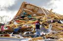 Gopala Penmetsa walks past his house after it was levelled by a tornado near Omaha (Chris Machian/Omaha World-Herald/AP)