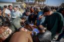 Iraqis sign a pledge to stand against homosexuality outside a mosque in Kufa (Anmar Khalil/AP)