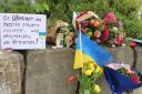 Flowers and a small Ukrainian flag were left at the scene (dpa via AP)