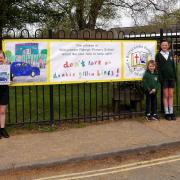 Winner Elsie with her artwork, and her two sisters