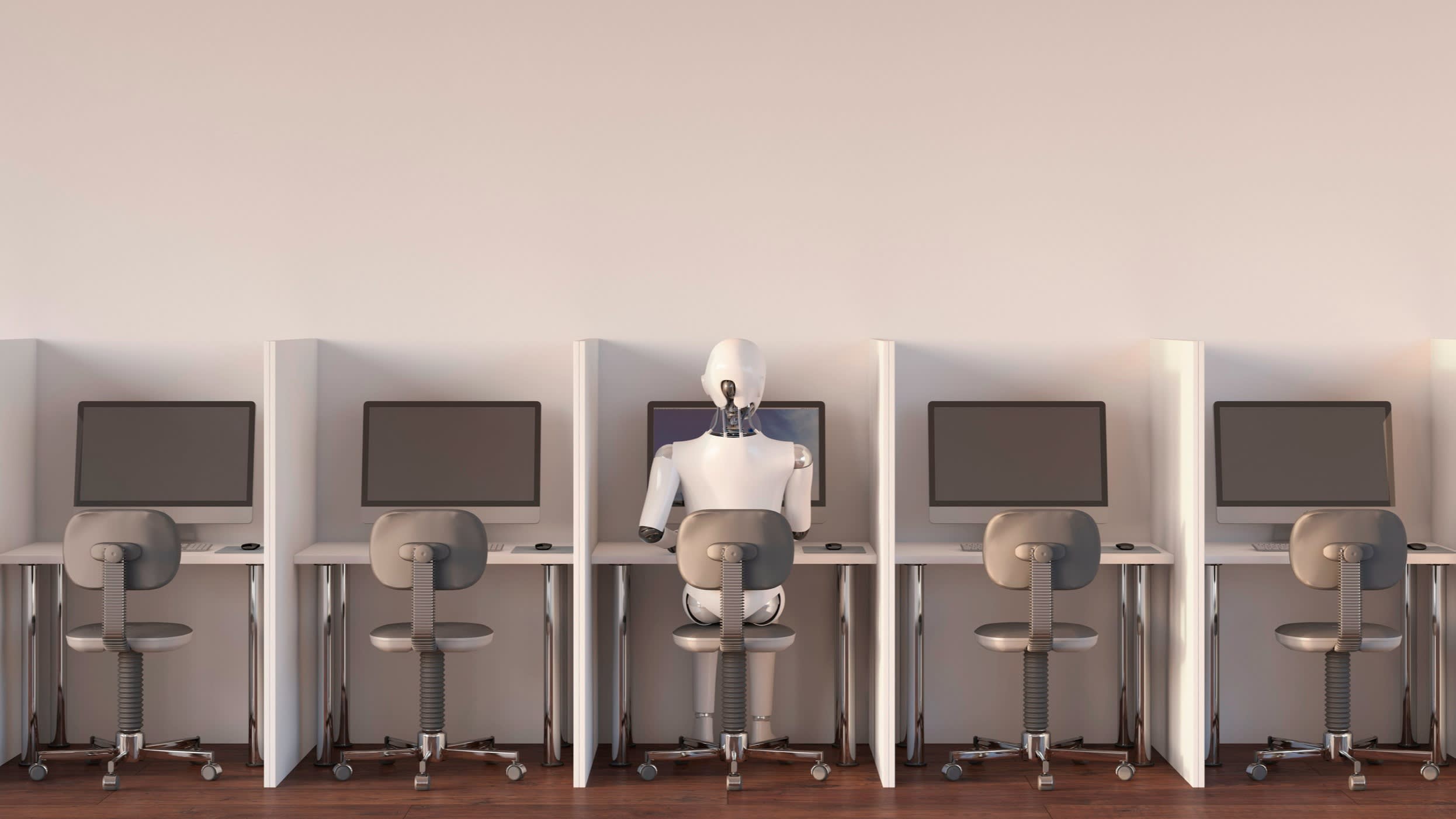 A robot sits at a bank of desks