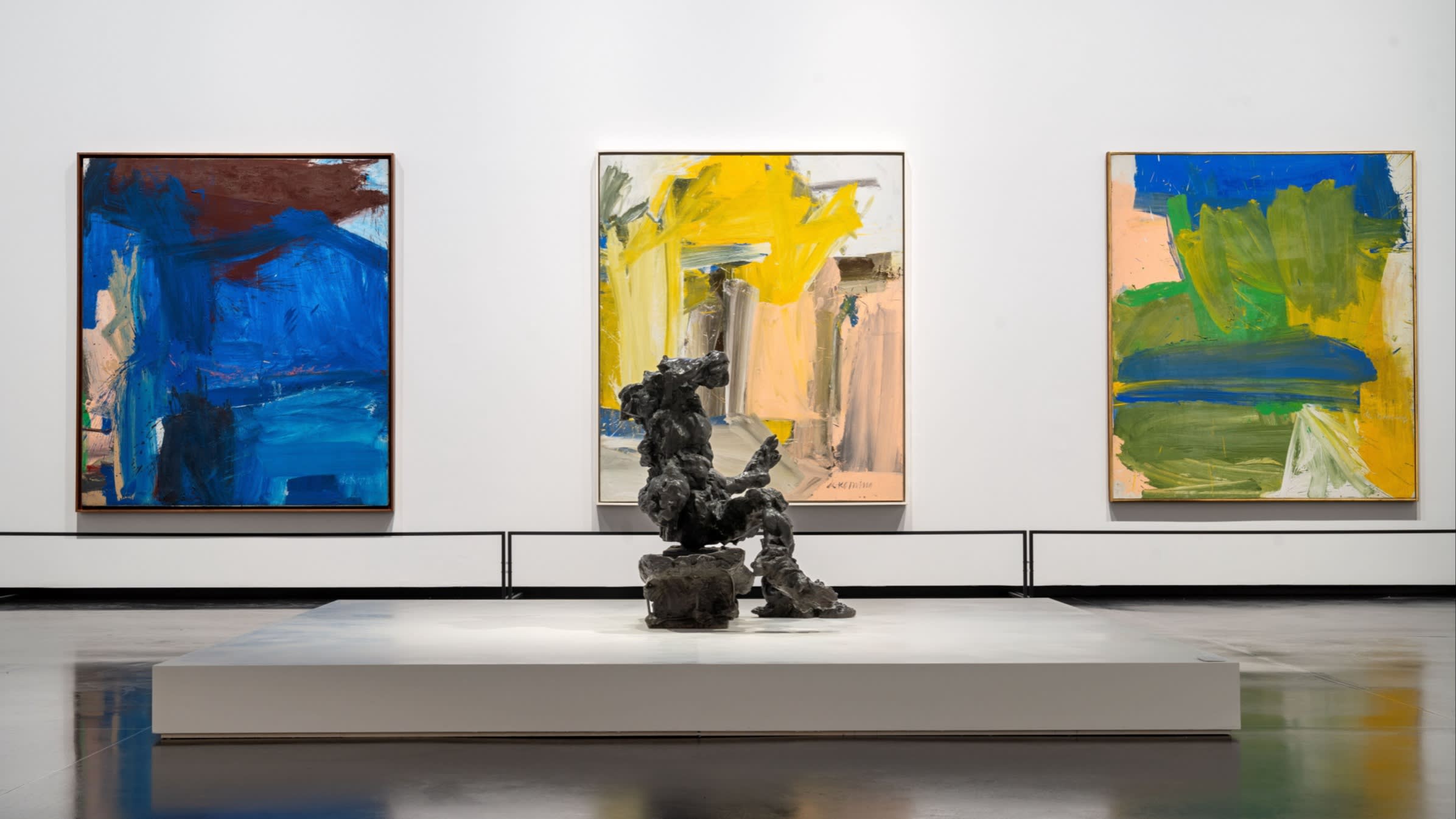 A view of a sculpture and a painting in a gallery