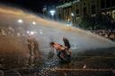 Riot police use a water cannon against protesters in Tbilisi (Zurab Tsertsvadze/AP)