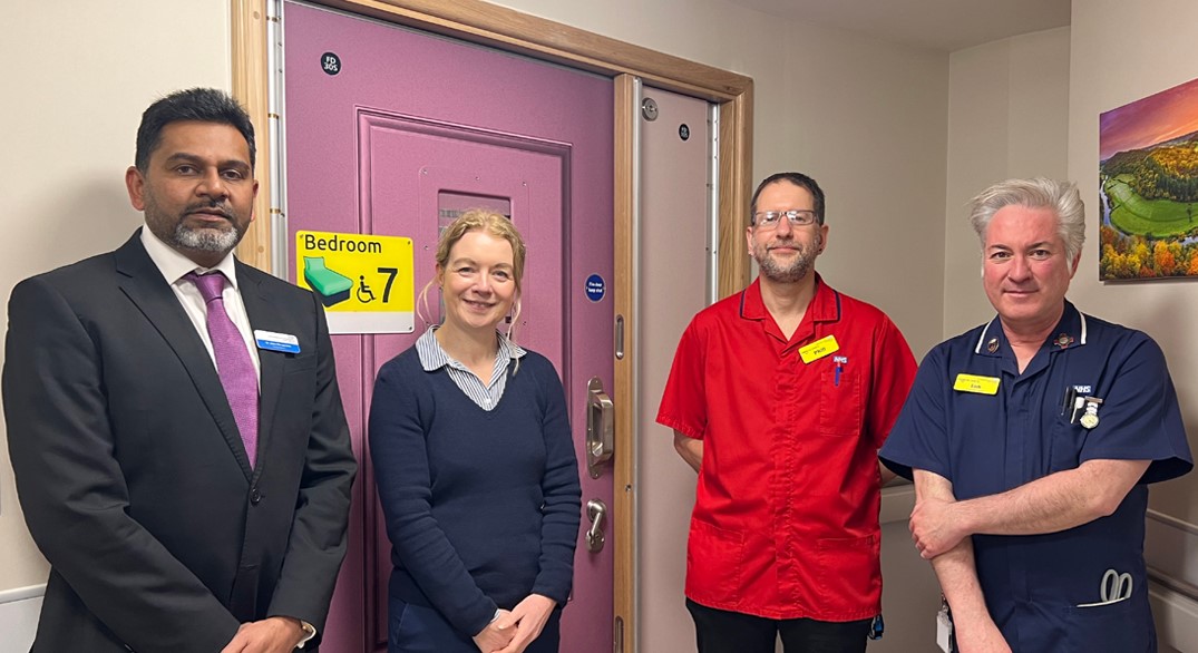 John Devapriam, Jayne Westwood, Phill Morgan Henshaw and Ian Richards infront of a patient bedroom on Cantilupe Ward