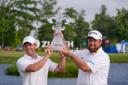 Rory McIlroy and Shane Lowry hold up their trophy after winning the PGA Zurich Classic golf tournament (Gerald Herbert/AP)