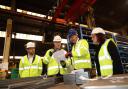 Jesse Norman (centre right) engaging with staff during a tour of the facility.