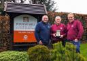 Edward Goddard presenting Les Preedy with watch. From left to right: previous owner Wayne Jones, Les Preedy, and Morris Leisure MD Edward Goddard