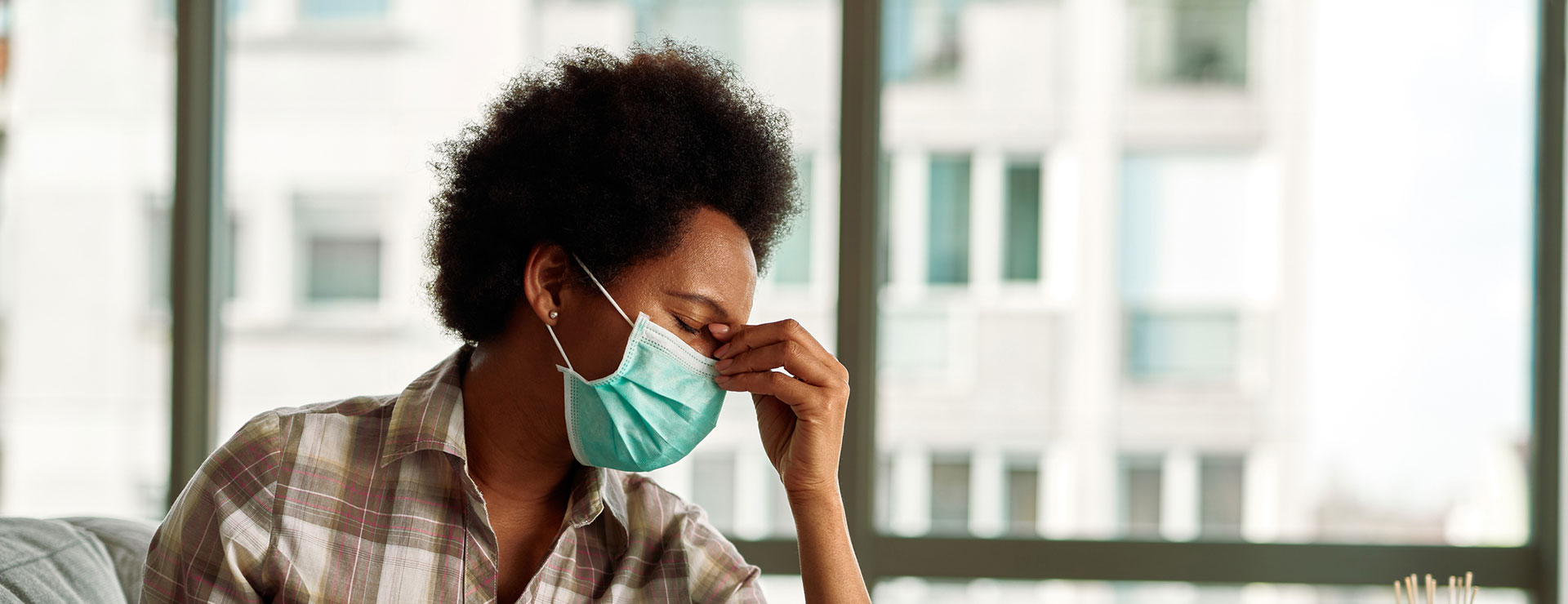 Woman pinching the bridge of her nose in frustration