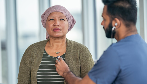 Doctor using stethoscope on female patient