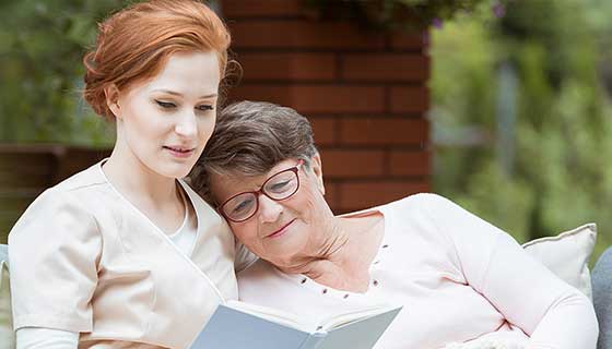 woman reading with caregiver