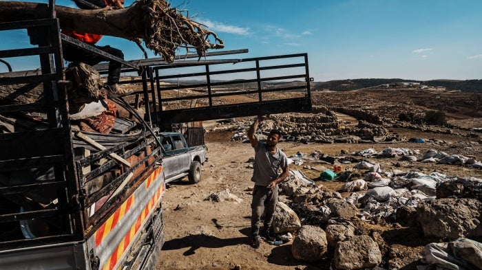 A family packs up their belongings in Khirbet Zanuta, in the southern West Bank, on October 30, 2023. Attacks by settlers, in some cases accompanied by soldiers, forced all the residents to leave.