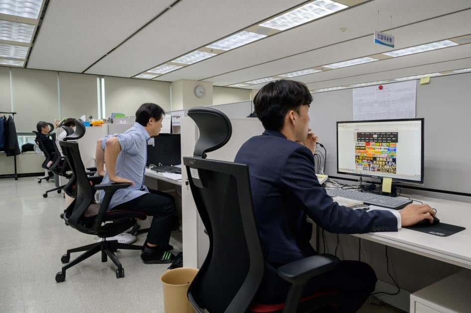 Men at desks in an office 