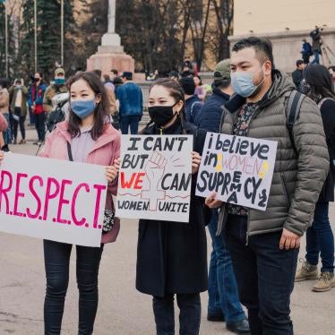 Protesters hold placards 