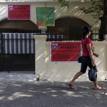 A sign on an Ahmadiyah mosque in South Jakarta, Indonesia reads, "This building is sealed due to inappropriate usage." The mosque was closed by government authorities in July 2015.