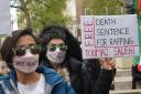 Protesters displayed placards and signs opposite Downing Street (Jeff Moore/PA)