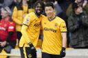 Wolves striker Hwang Hee-Chan, right, celebrates with team-mate Boubacar Traore after scoring against Luton (Nick Potts/PA)