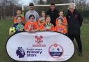 St Bart’s girls’ football team with Harriers’ players Shane Byrne and Christian Oxlade-Chamberlain and community sports manager Nick Griffiths