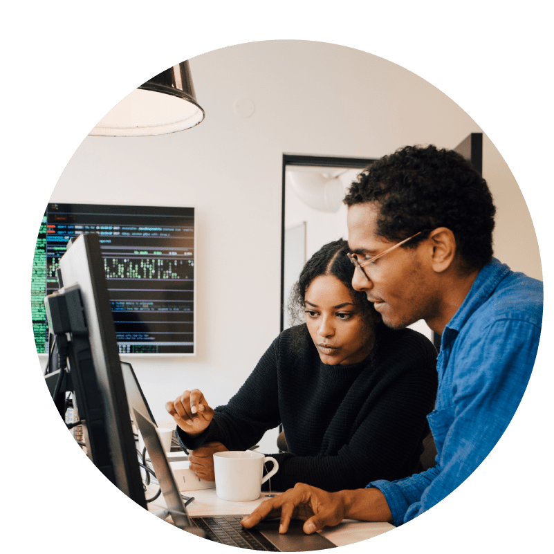 Two people working at a computer together in discussion. Overlaid Limeade icons for the science of care and technology solutions.