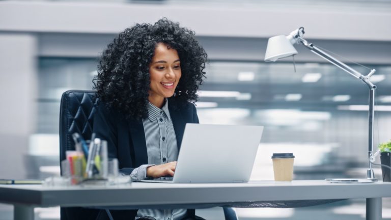 Employee accessing resources on her laptop | Limeade well-being programs