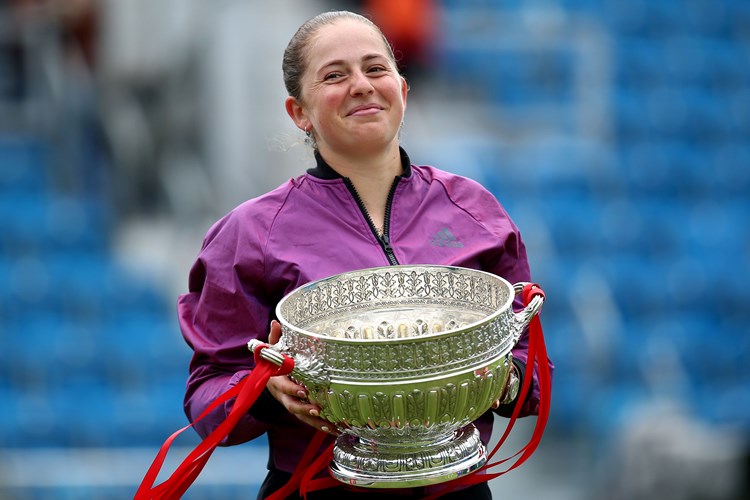 Female tennis player holding a trophy