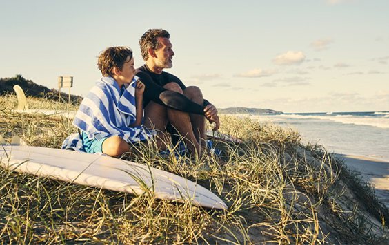 Father and young son looking out to the sea