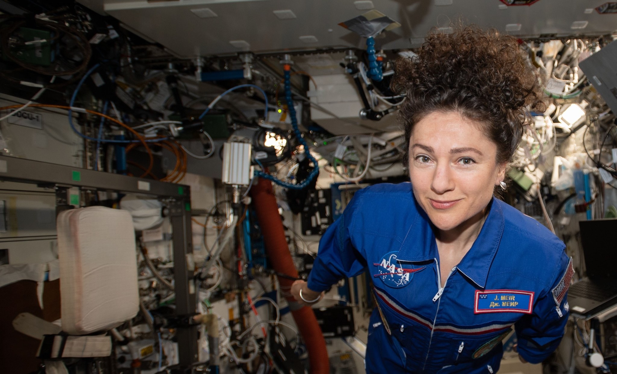 NASA astronaut and Expedition 62 Flight Engineer Jessica Meir, wearing the "Penguin (пингвин)" suit, poses for a portrait in the U.S. Laboratory.