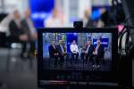 A Nasdaq moderator, center, talks with NASA Director of Commercial Spaceflight Development Phil McAlister, left