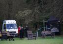 Police at Gravelly Hill in Caterham, Surrey, where a dog attacked members of the public on Thursday. A woman in her 20s was pronounced dead at the scene