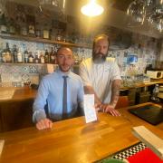 Gianluca La Porta and Fabio Giacalone with the unpaid £280 bill after they were bilked by a large group