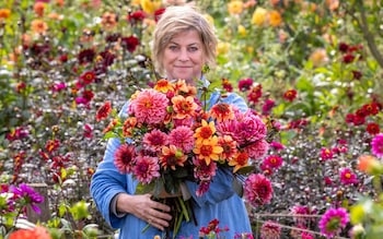 Sarah with bunch of Sarah Raven exclusive dahlias. Dahlia 'Perch Hill'